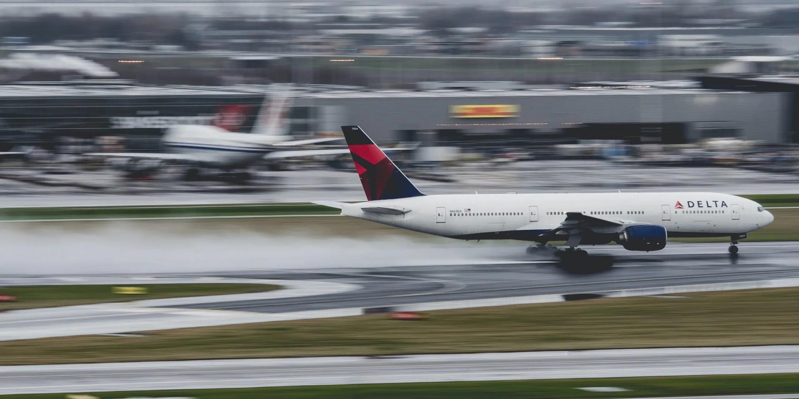 delta airplane taking off on a wet runway